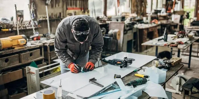 a person working with plexiglass and wood